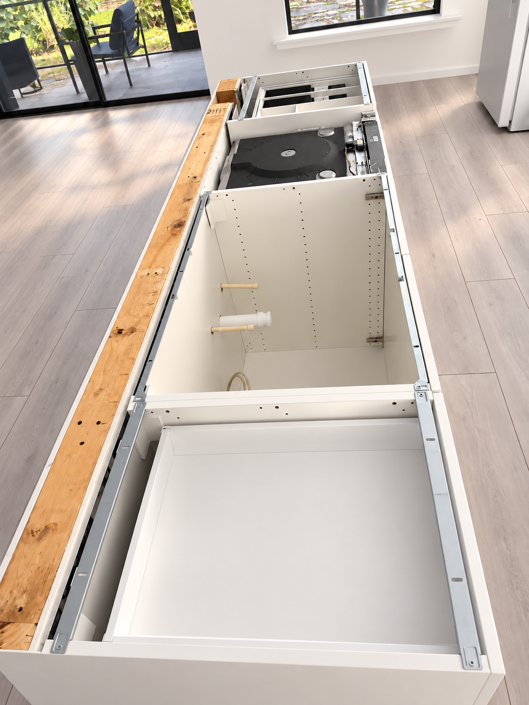 Kitchen island cabinetry and plumbing before countertop installation